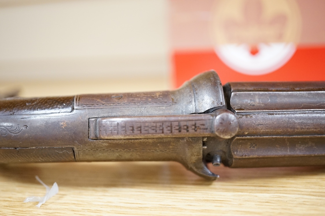 A six shot 120 bore self-cocking percussion pepperbox revolver with fluted barrels, Birmingham proof, rounded foliate engraved frame, and two-piece chequered walnut grips
